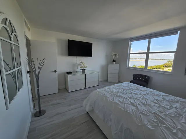 a bedroom with a bed and a flat screen tv