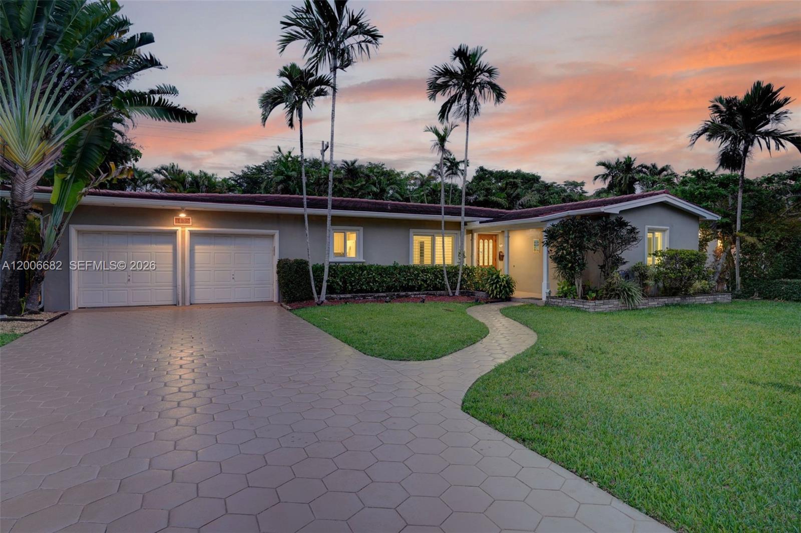 1435 Blue Road Coral Gables, FL 33146 - Photo 3 of 31 a front view of a house with garden