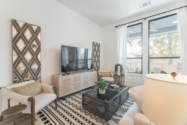 a living room with furniture and a large window