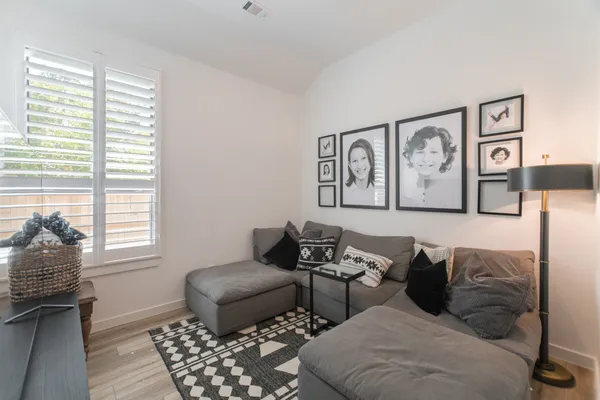 a living room with furniture and wall paintings