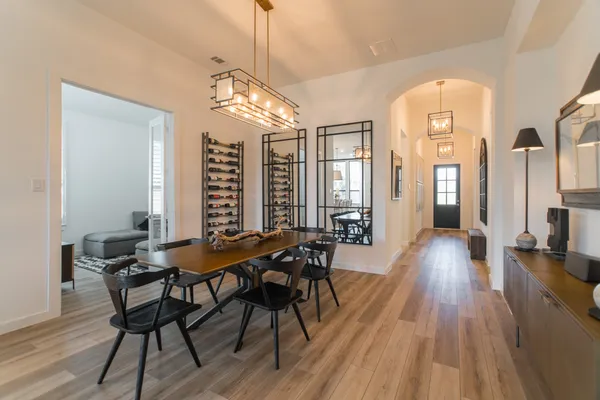 a view of a dining room with furniture wooden floor and chandelier