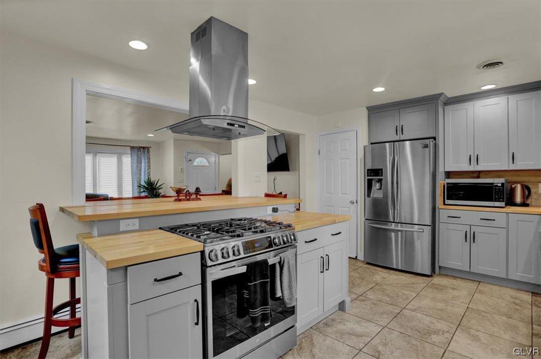 210 Rothermel Boulevard Reading, PA 19605 - Photo 11 of 26 a kitchen with stainless steel appliances granite countertop a stove and a refrigerator