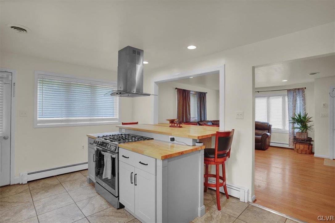 210 Rothermel Boulevard Reading, PA 19605 - Photo 13 of 26 a kitchen that has a stove and a table in it