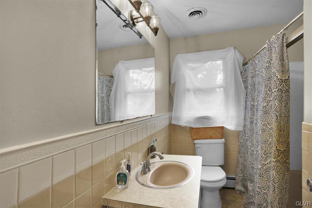 210 Rothermel Boulevard Reading, PA 19605 - Photo 21 of 26 a bathroom with a sink toilet a mirror and shower