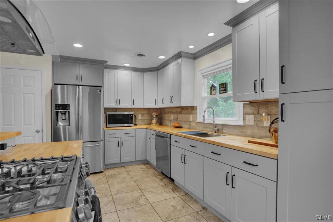 210 Rothermel Boulevard Reading, PA 19605 - Photo 10 of 26 a kitchen with a sink stove and refrigerator