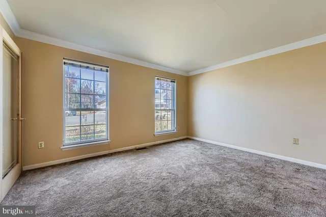 a view of an empty room with a window and balcony