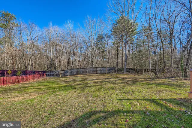 a house view with swimming pool in front of it
