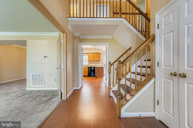 a view of an entryway with wooden floor and door