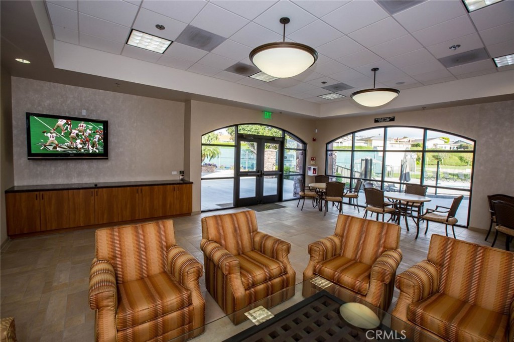 33571 Binnacle Drive Dana Point, CA 92629 - Photo 40 of 48 a living room with furniture floor to ceiling window and a flat screen tv