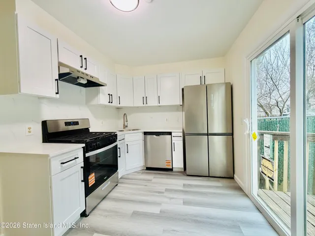 a kitchen with stainless steel appliances a refrigerator stove and microwave