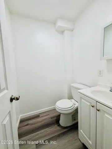 a white toilet sitting next to a shower