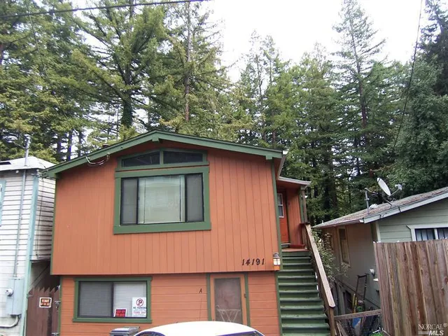 a front view of a house with trees