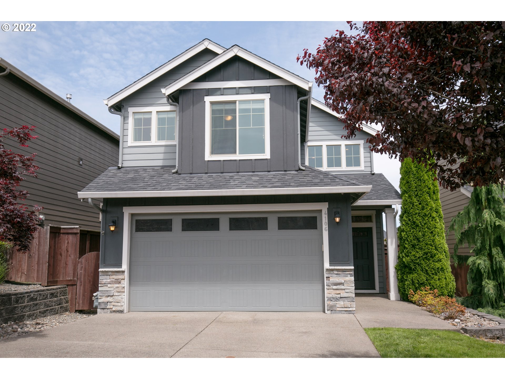 4106 North 5th Way Ridgefield, WA 98642 - Photo 1 of 26 a front view of a house with a garden
