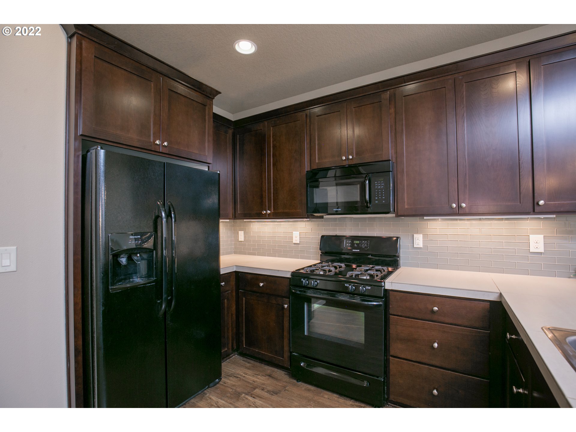 4106 North 5th Way Ridgefield, WA 98642 - Photo 5 of 26 a kitchen with a refrigerator and a sink
