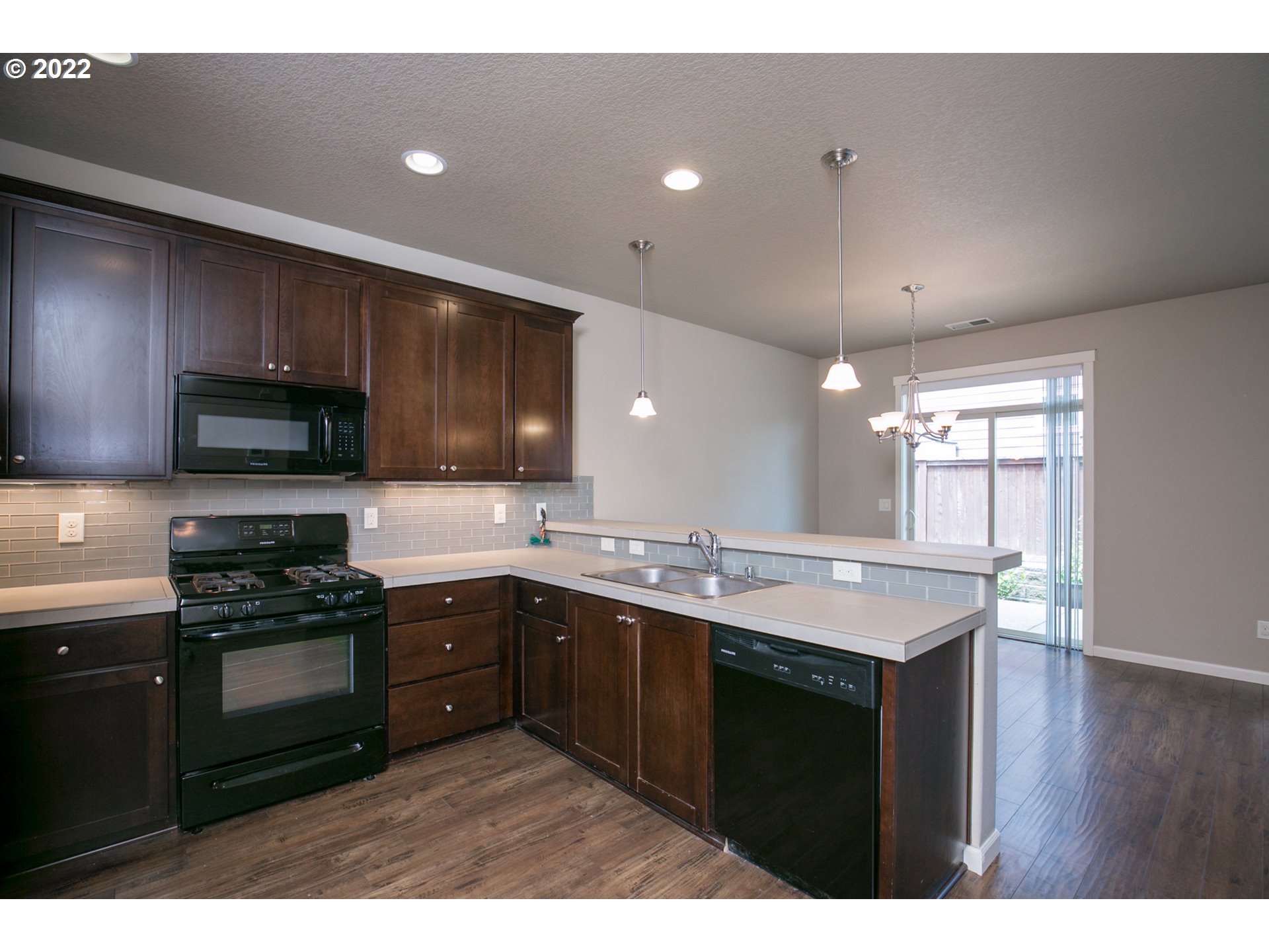4106 North 5th Way Ridgefield, WA 98642 - Photo 6 of 26 a kitchen with a sink a stove and cabinets