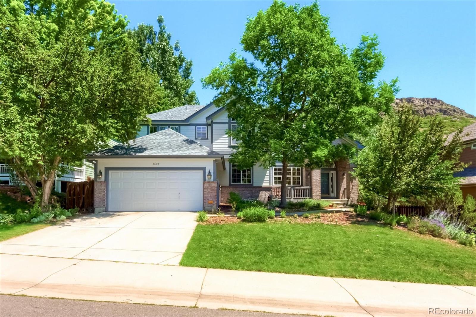 a front view of a house with a yard and a garage