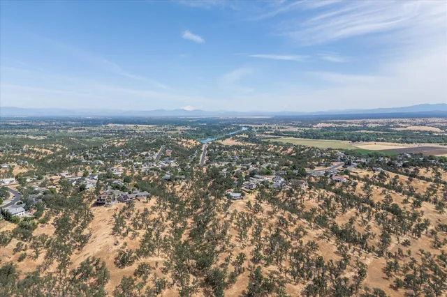 front view of a house with a garden and a car parked