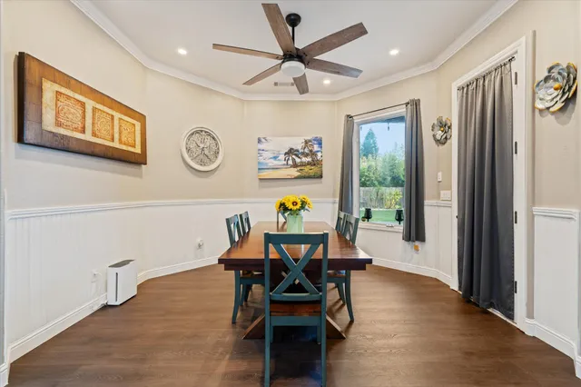 a view of a dining room with furniture and chandelier