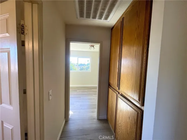 a view of a hallway with wooden floor and staircase