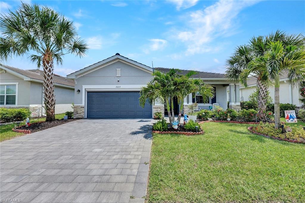2622 Scarlet Way Naples, FL 34120 - Photo 1 of 24 a front view of a house with yard and green space