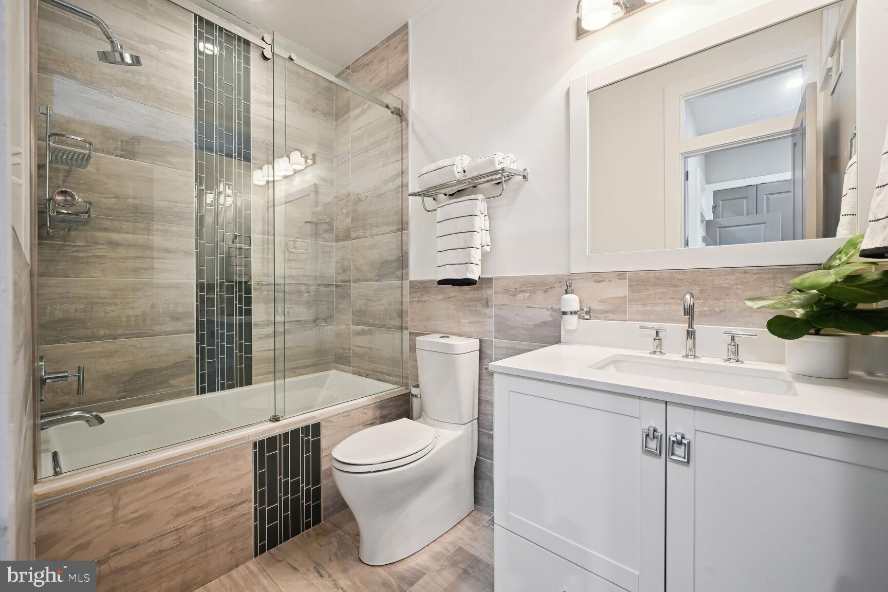 1143 5th Street Northeast, Unit 1 Washington, DC 20002 - Photo 14 of 54 a bathroom with a sink toilet and shower