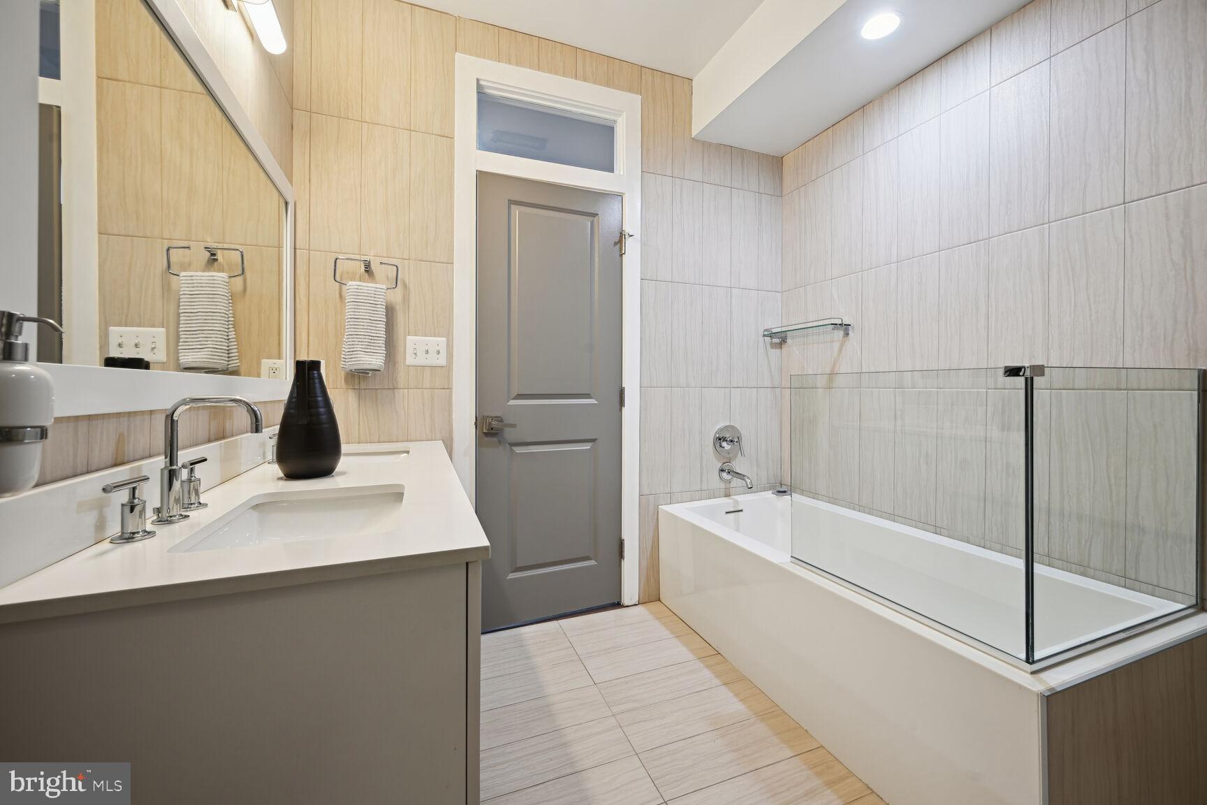 1143 5th Street Northeast, Unit 1 Washington, DC 20002 - Photo 21 of 54 a bathroom with a bathtub and a sink