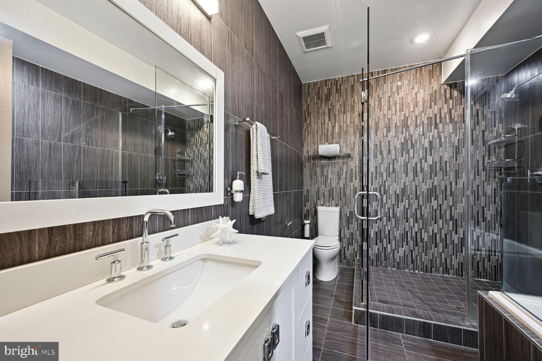 1143 5th Street Northeast, Unit 1 Washington, DC 20002 - Photo 24 of 54 a bathroom with a sink double vanity and a shower