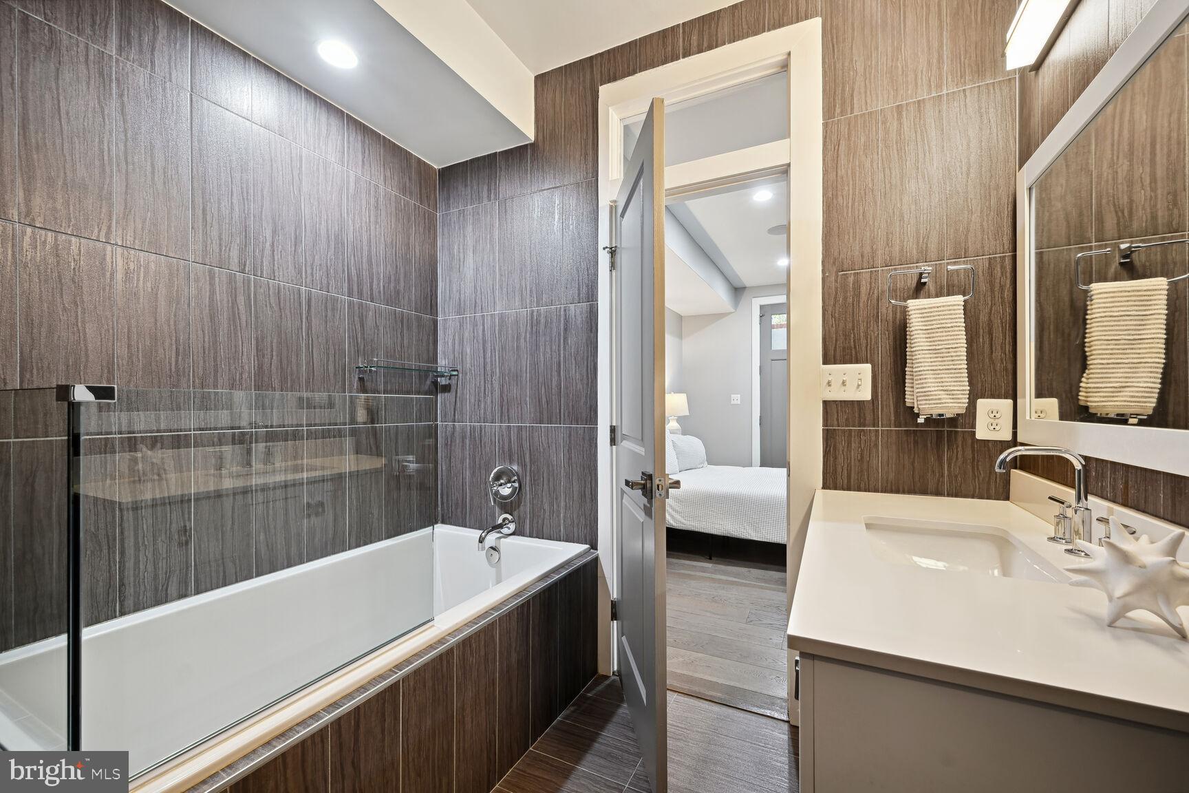 1143 5th Street Northeast, Unit 1 Washington, DC 20002 - Photo 25 of 54 a bathroom with a bathtub and a sink