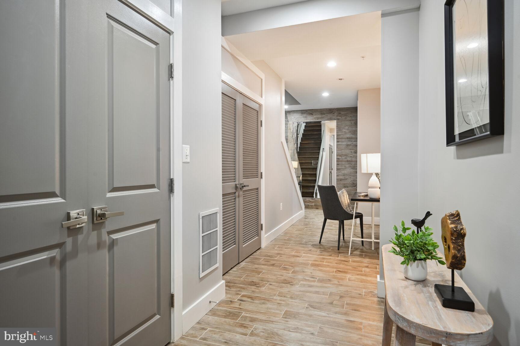 1143 5th Street Northeast, Unit 1 Washington, DC 20002 - Photo 27 of 54 a hallway with furniture and a potted plant