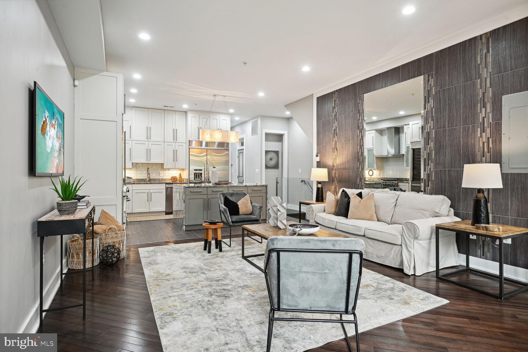 1143 5th Street Northeast, Unit 1 Washington, DC 20002 - Photo 4 of 54 a living room with furniture kitchen view and a wooden floor