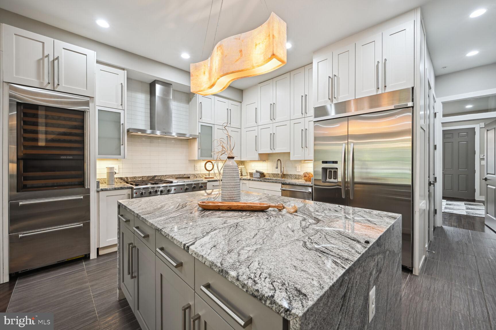 1143 5th Street Northeast, Unit 1 Washington, DC 20002 - Photo 8 of 54 a kitchen with stainless steel appliances granite countertop a sink stove and refrigerator