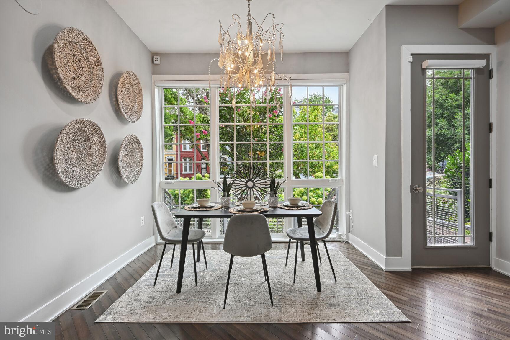 1143 5th Street Northeast, Unit 1 Washington, DC 20002 - Photo 9 of 54 a view of a dining room with furniture a chandelier and wooden floor