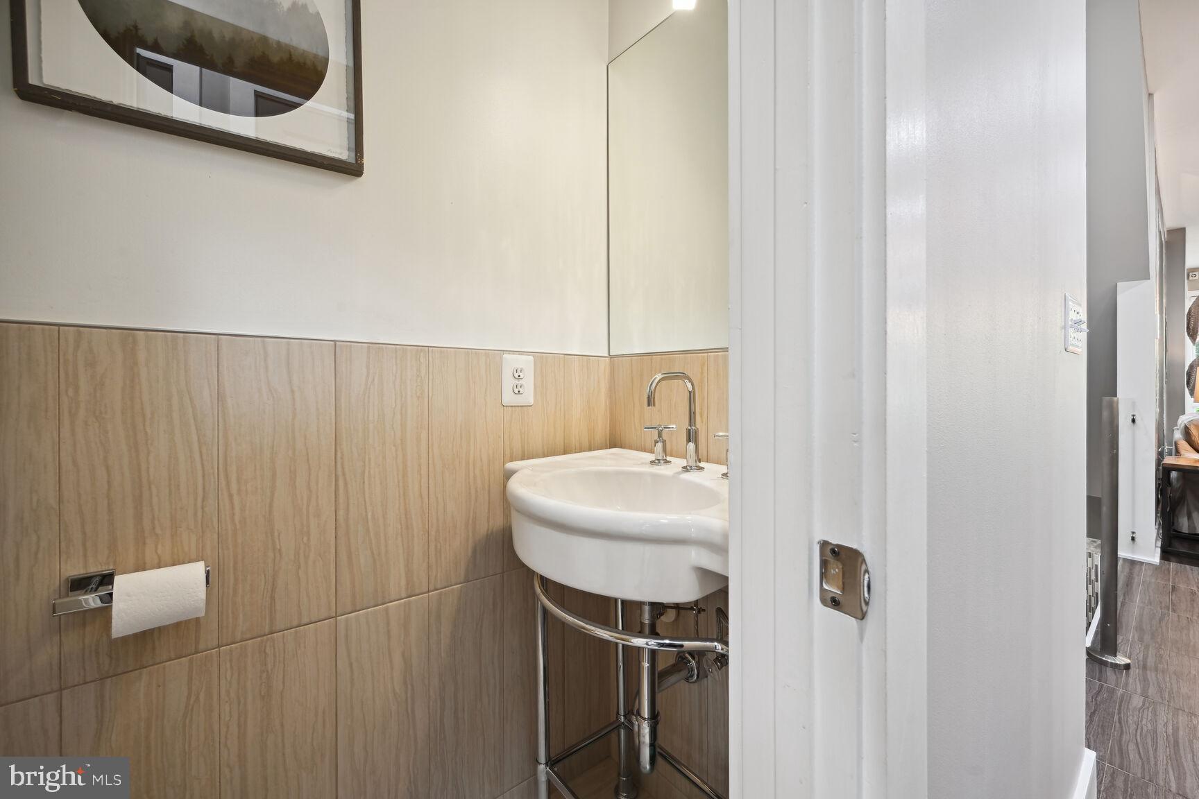 1143 5th Street Northeast, Unit 1 Washington, DC 20002 - Photo 10 of 54 a bathroom with a sink and a mirror
