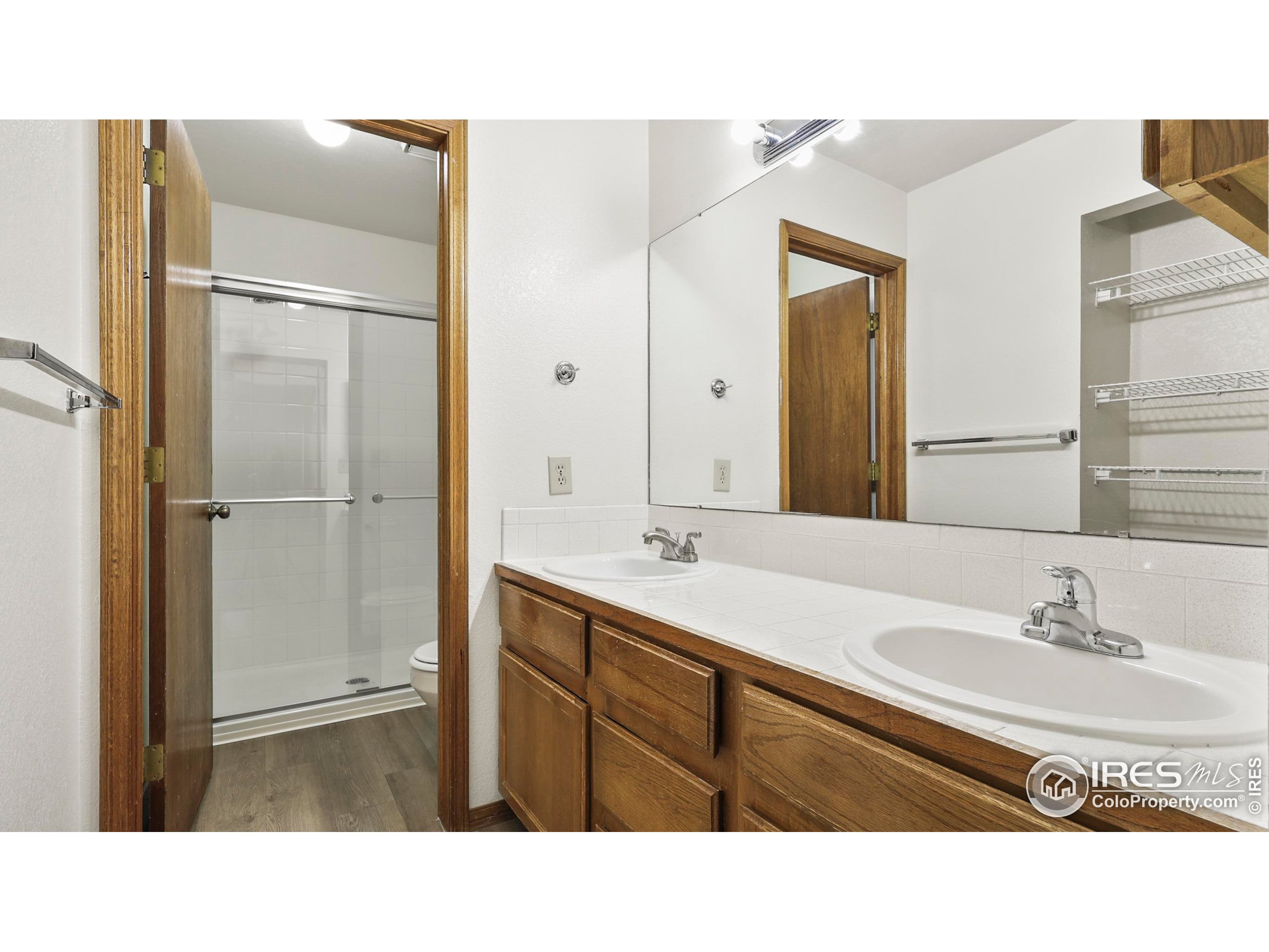 5809 West 18th Street Greeley, CO 80634 - Photo 18 of 25 a bathroom with a sink a mirror and a shower