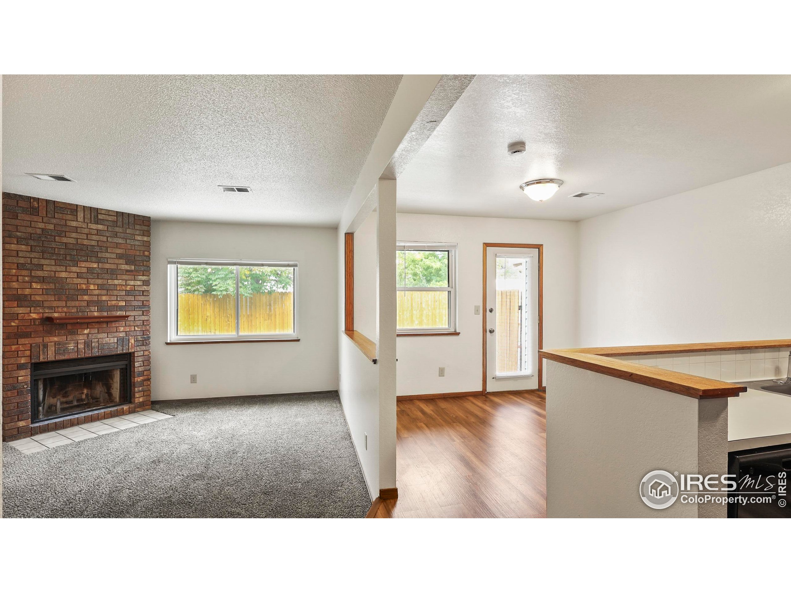 5809 West 18th Street Greeley, CO 80634 - Photo 5 of 25 a open kitchen with furniture and a fireplace