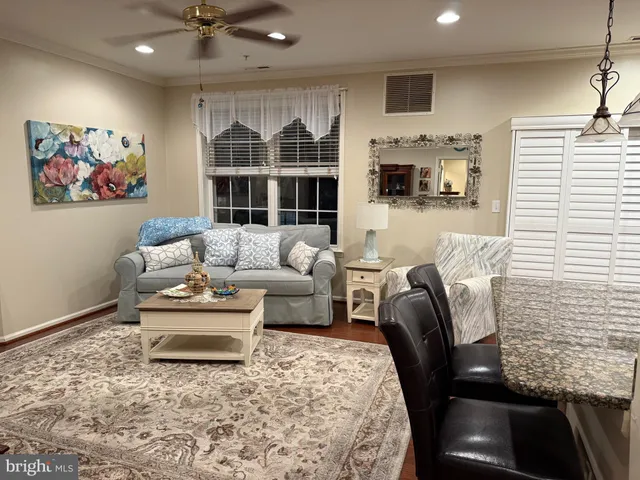 a living room with a flat screen tv and cabinets