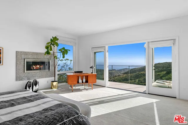 a bedroom with a bed couch and window