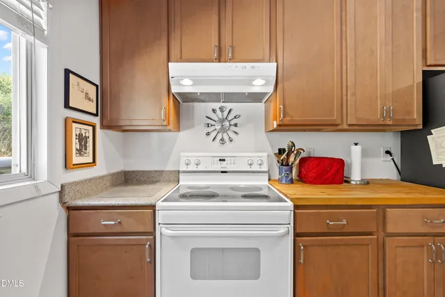 a kitchen with stainless steel appliances granite countertop a sink stove and microwave