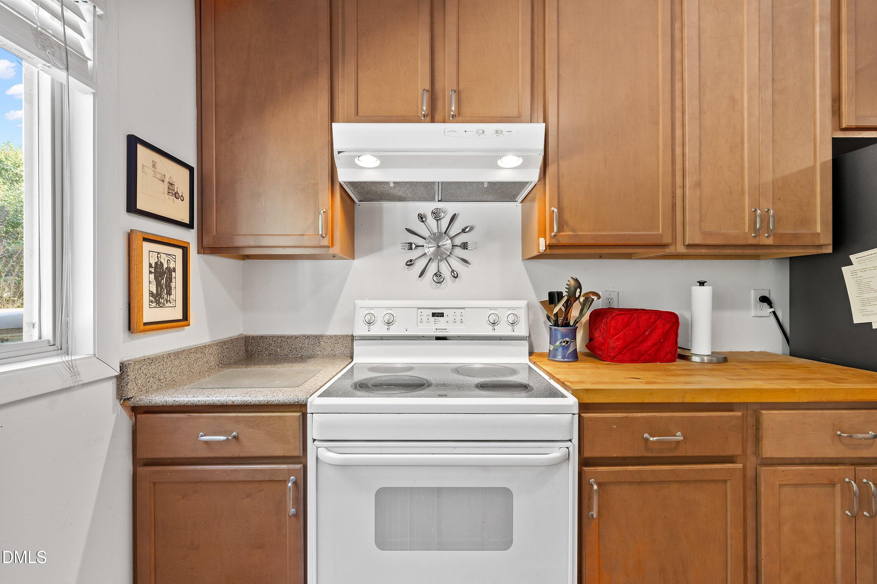 1445 Sedwick Road Durham, NC 27713 - Photo 13 of 48 a kitchen with a stove and a sink