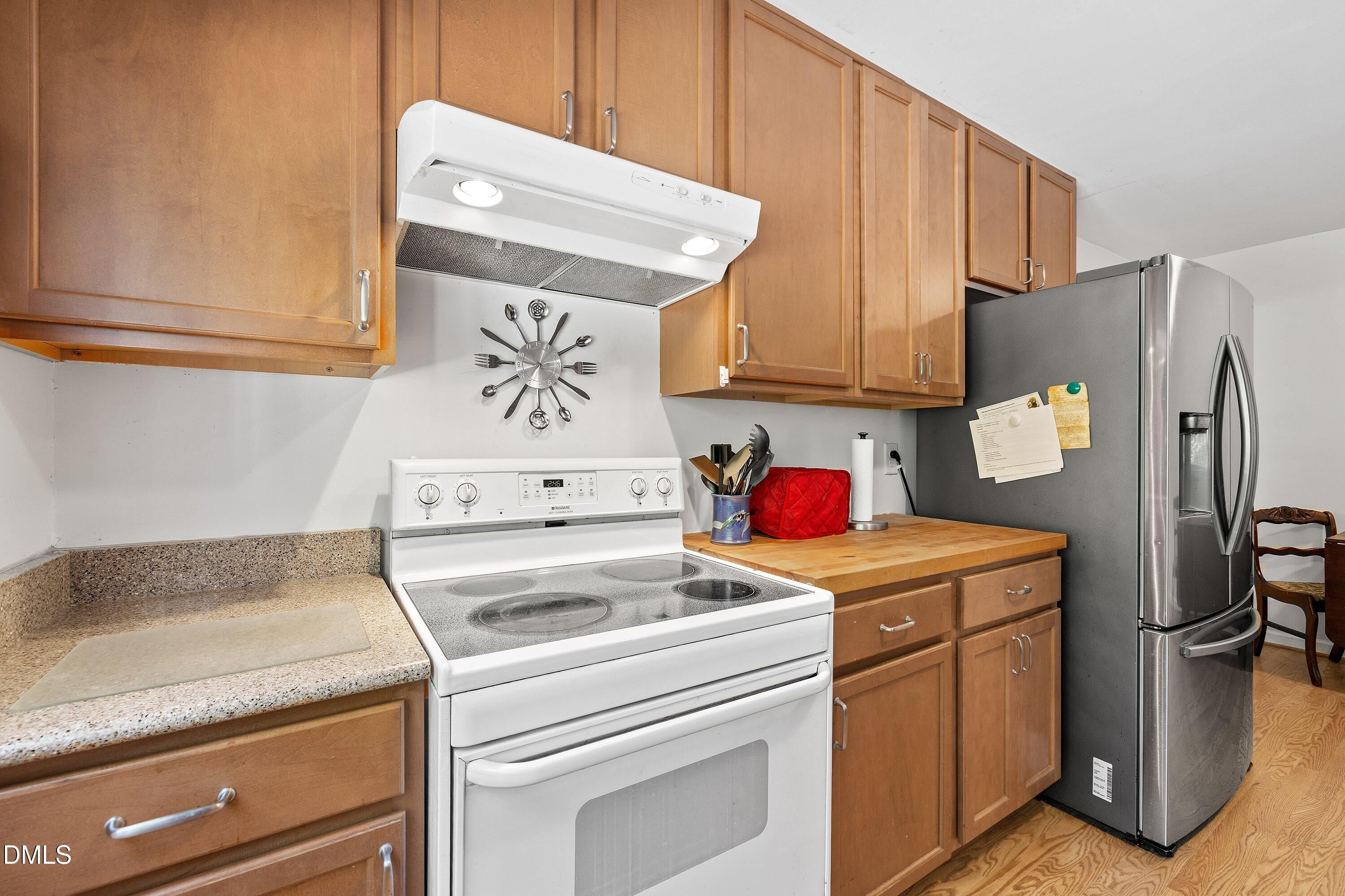 1445 Sedwick Road Durham, NC 27713 - Photo 14 of 48 a kitchen with refrigerator and cabinets