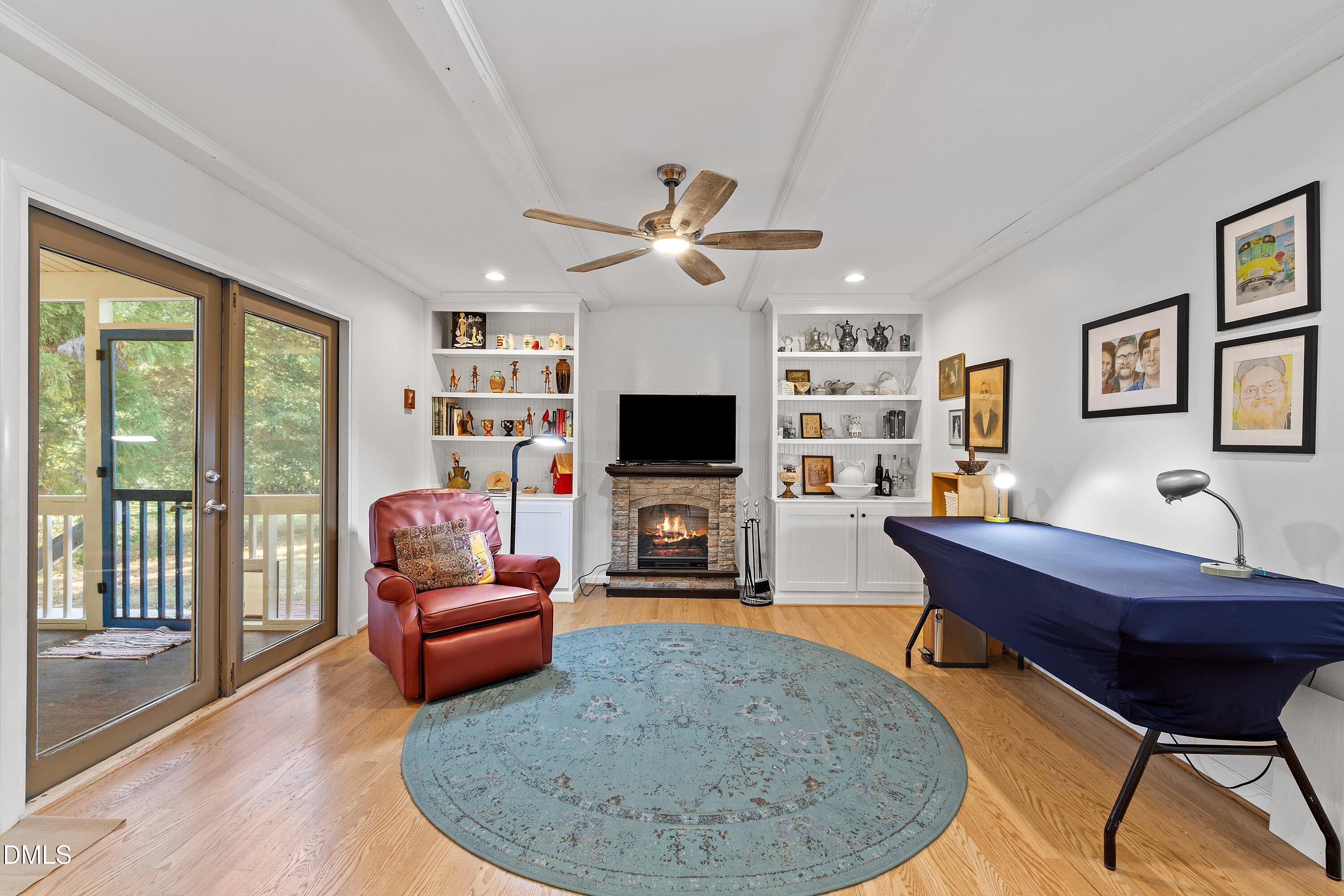 1445 Sedwick Road Durham, NC 27713 - Photo 15 of 48 a living room with furniture a flat screen tv and a fireplace