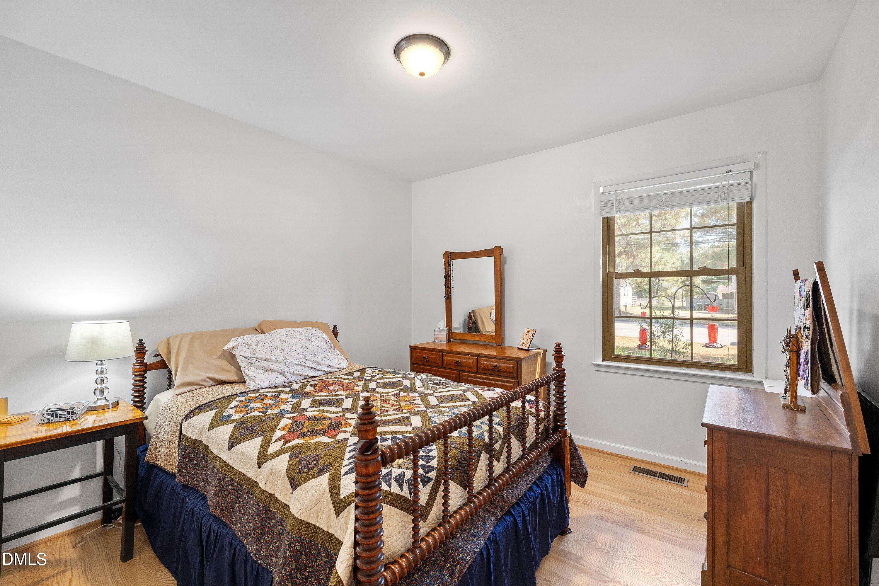 1445 Sedwick Road Durham, NC 27713 - Photo 23 of 48 a bedroom with a bed and a window