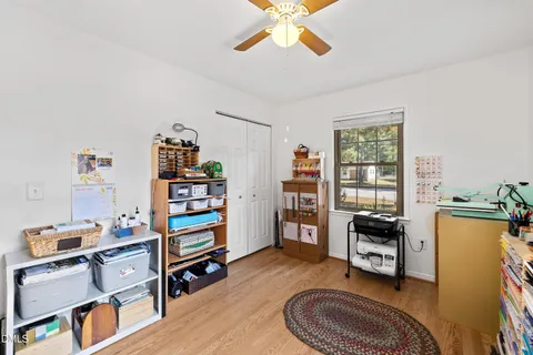 a view of a workspace with furniture and a window
