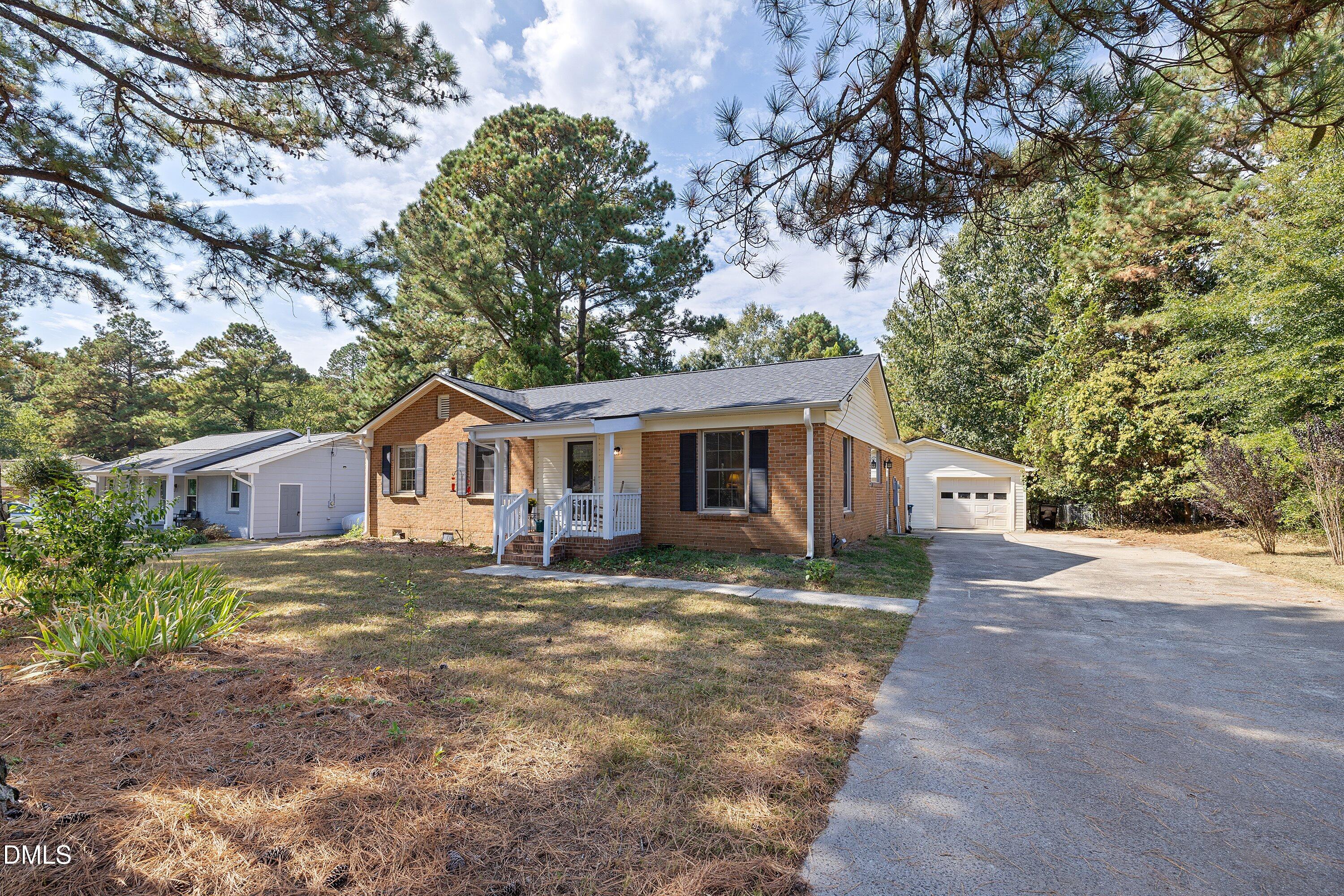 1445 Sedwick Road Durham, NC 27713 - Photo 2 of 48 a front view of a house with a garden and trees