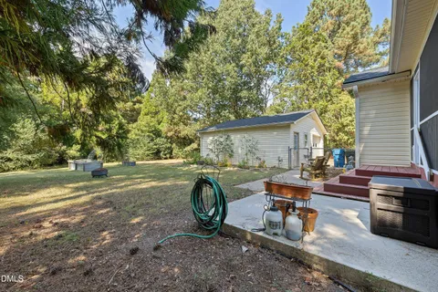 a view of a deck with table and chairs with wooden floor and fence