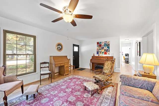 a living room with furniture and a piano
