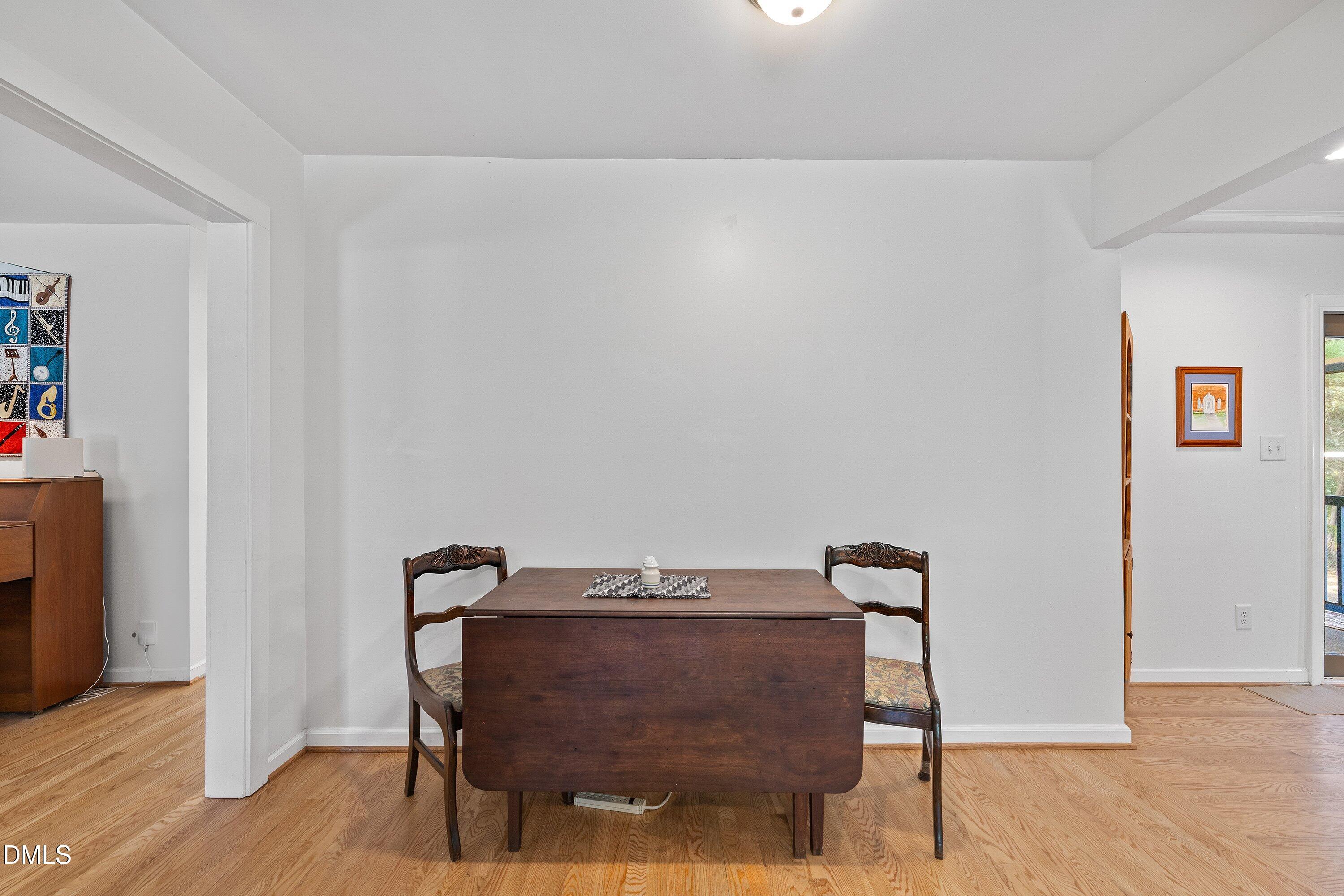 1445 Sedwick Road Durham, NC 27713 - Photo 9 of 48 a view of a workspace with furniture and wooden floor