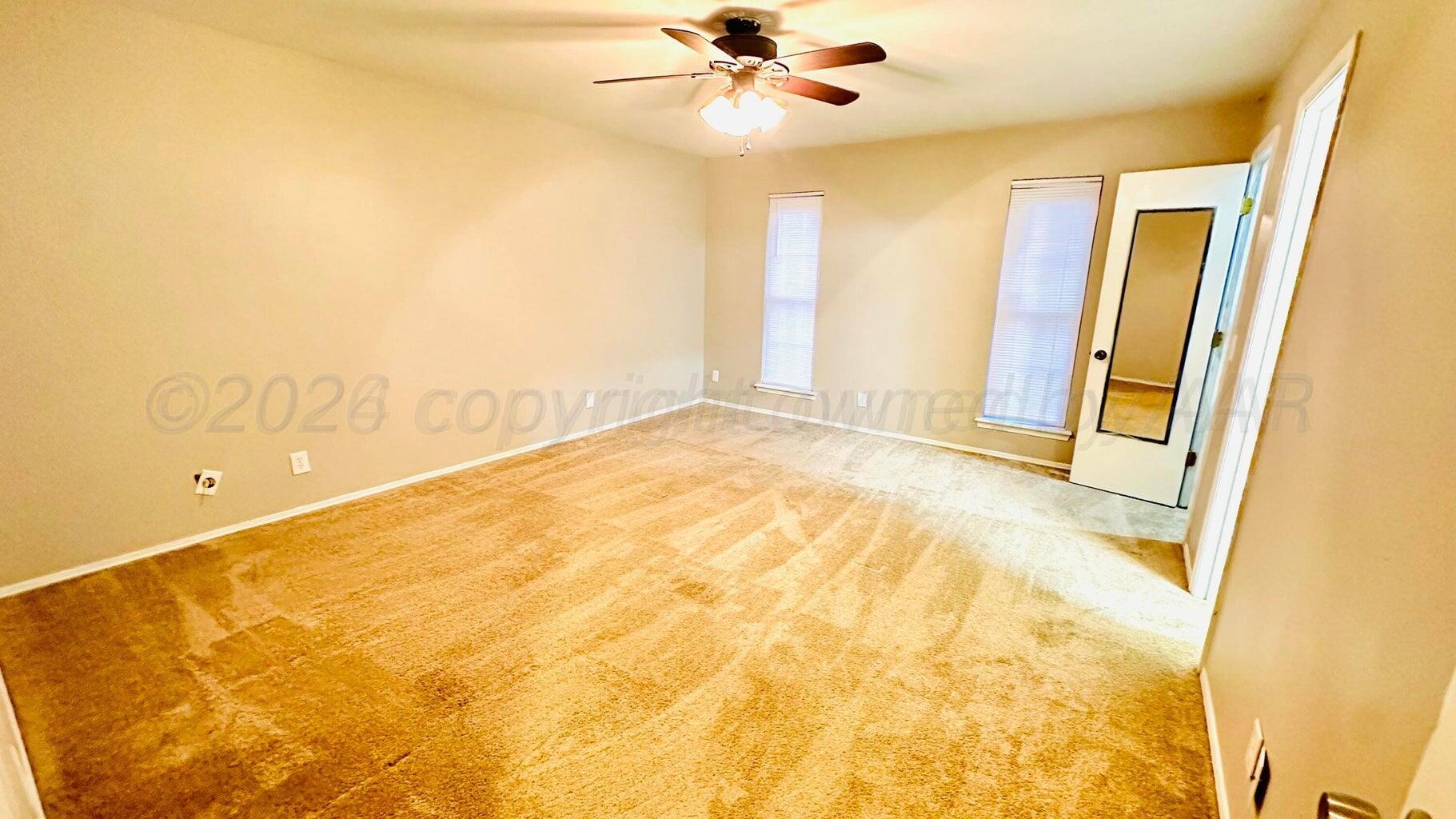 6820 Rochelle Lane Amarillo, TX 79109 - Photo 13 of 18 a view of an empty room with a window