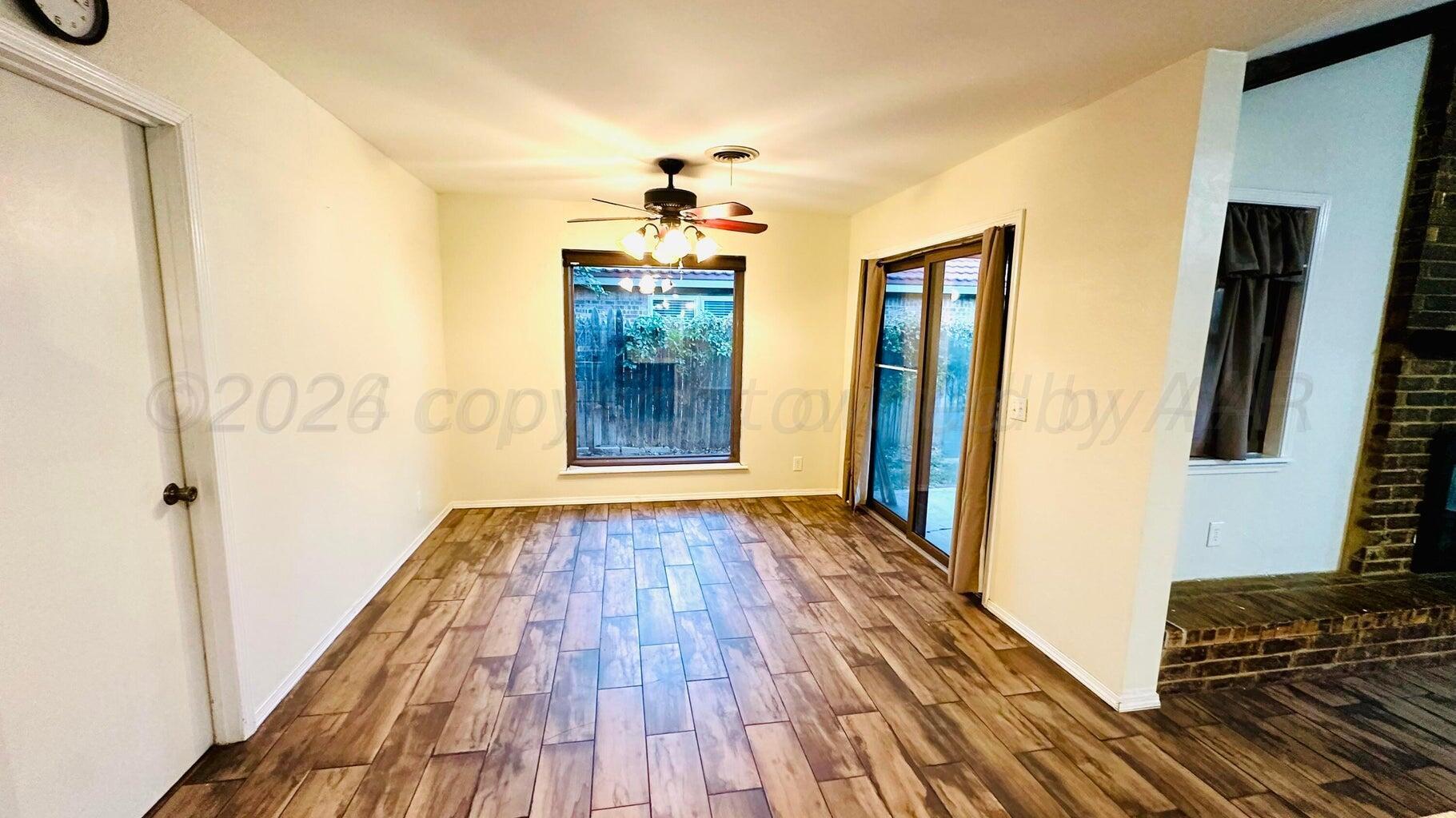 6820 Rochelle Lane Amarillo, TX 79109 - Photo 8 of 18 a view of hallway with wooden floor and staircase