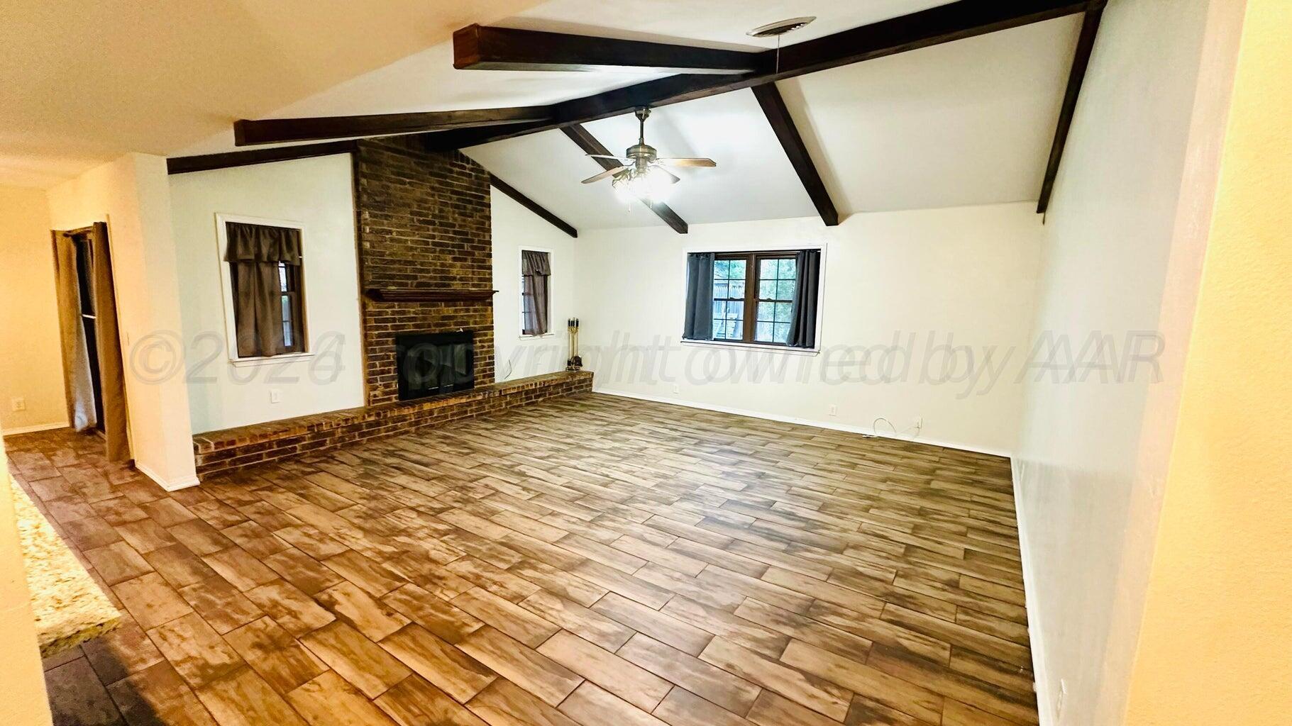 6820 Rochelle Lane Amarillo, TX 79109 - Photo 9 of 18 a view of empty room with wooden floor and fan